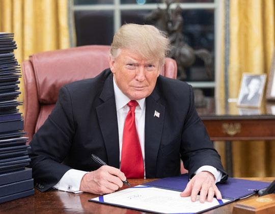 Photo shows President Trump in the Oval Office in December 2018. Photo Credit: Alamy Stock Photo (Creative Commons License)