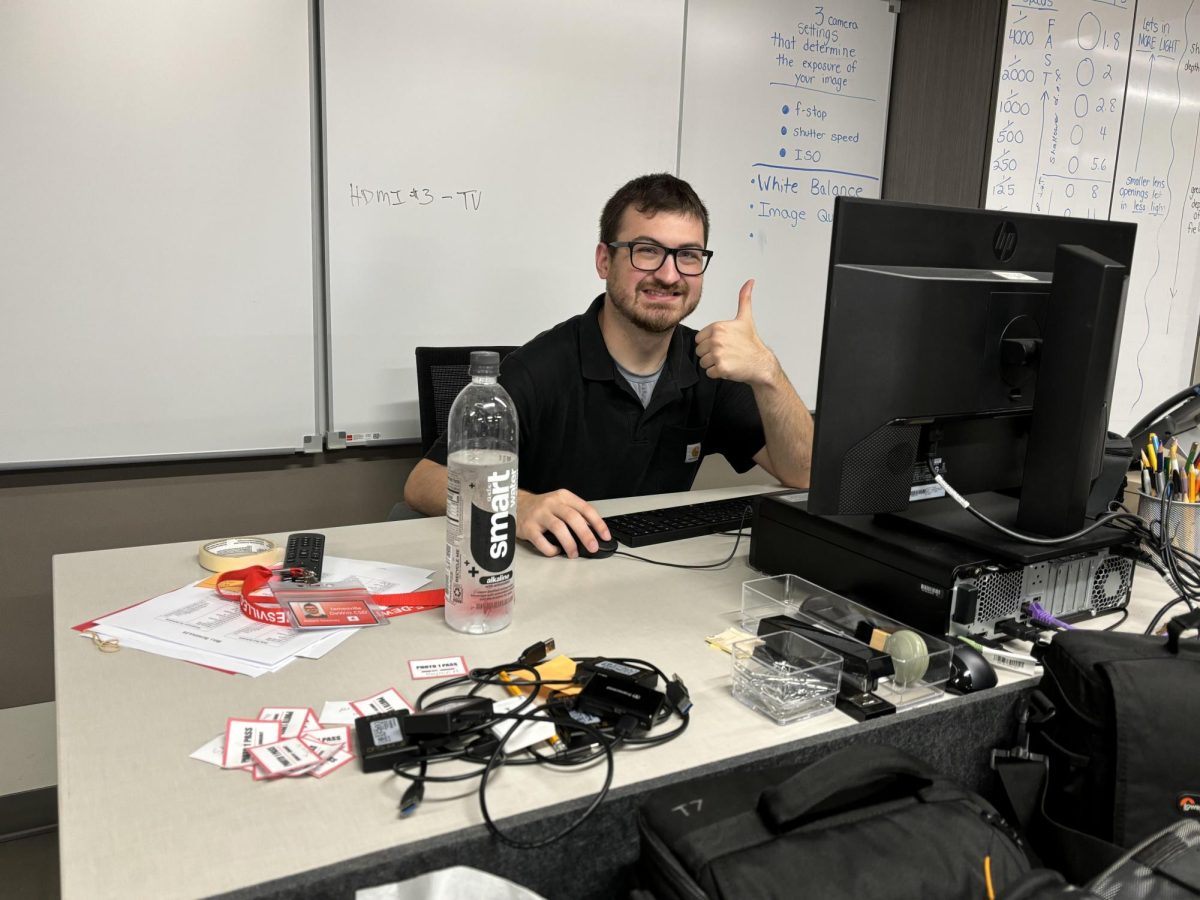 Photo shows Robert Sweeney sitting at his desk. Photo courtesy of Nicole Chen, '26