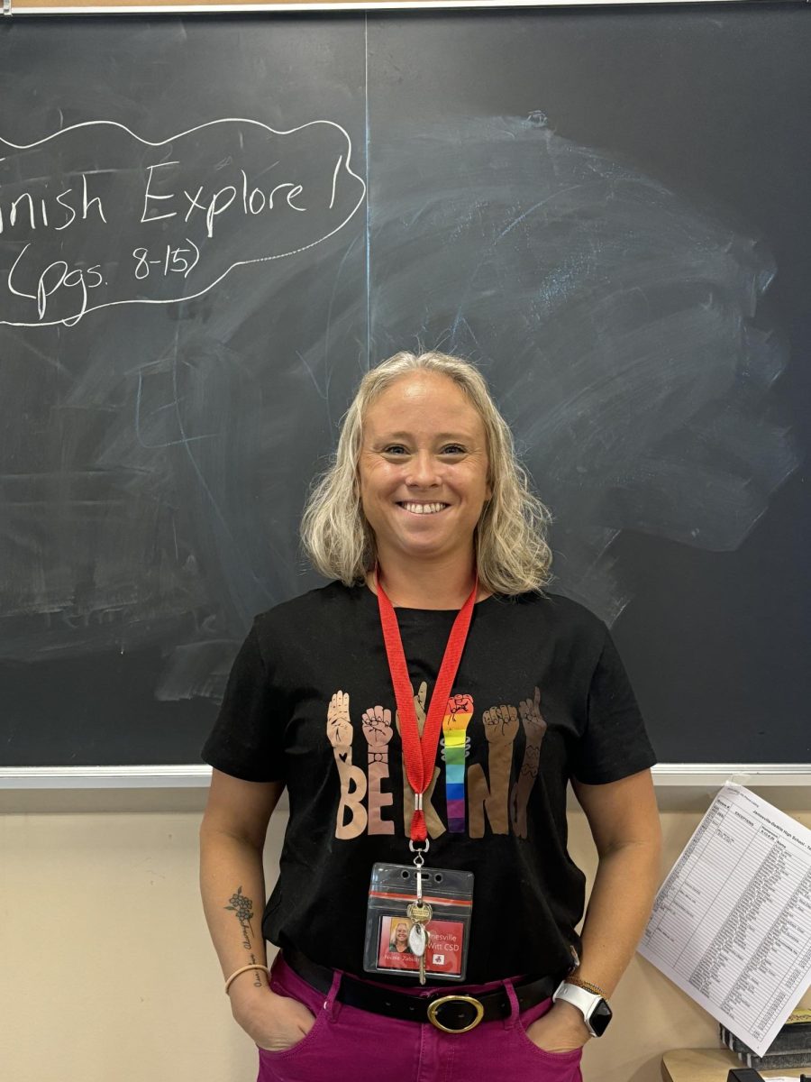 Photo shows Nicole Zablotny standing in front of a chalkboard. Photo courtesy of Nicole Chen, '26