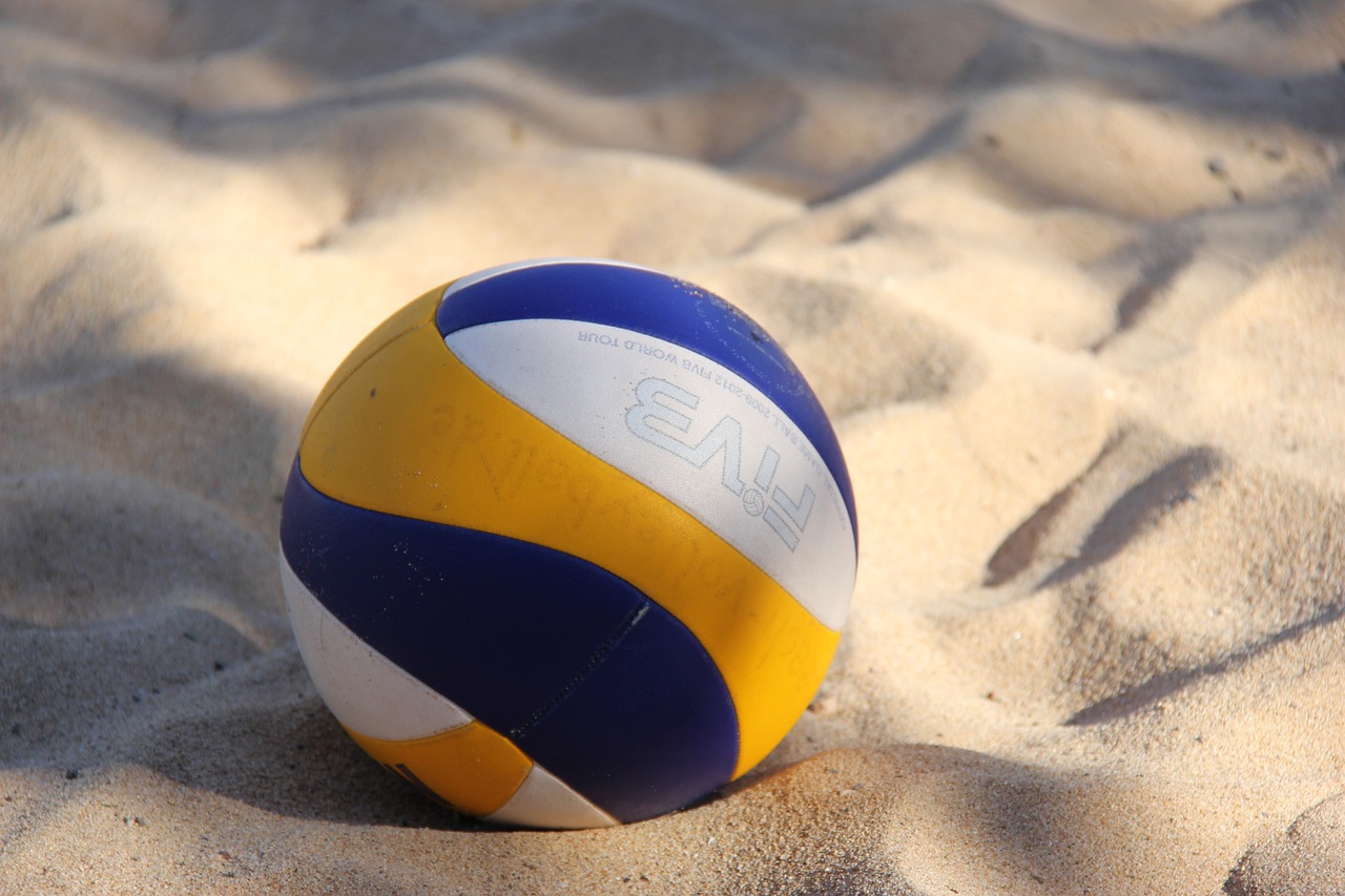 Photo shows volleyball on the sand. Photo courtesy of wolfganggerth on Pixabay.